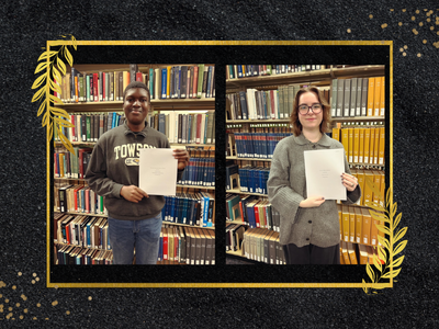 Two students holding their award winning papers on a black background with gold leaves
