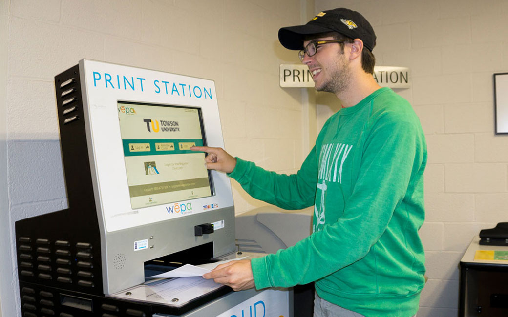 A student demonstrates a wepa printing station