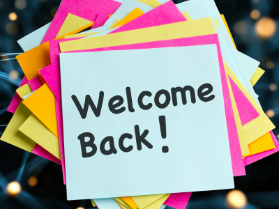 Welcome Back! on a pile of post-it notes
