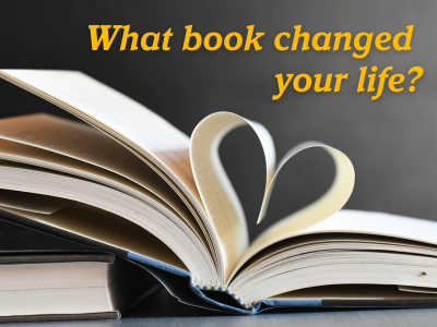 Book on a slant with pages folded into a heart and the words What book changed your life? above it