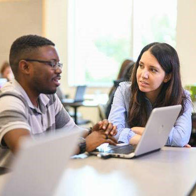 A faculty member in deep discussion